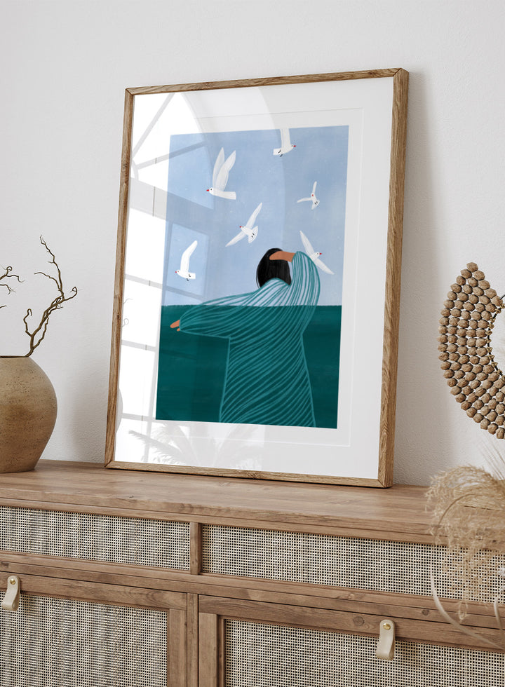 Seaside Serenity by Bea Müller is an officially licensed art print featuring a calm seaside figure and flying birds. Available as fine art print or framed with real wood frames.