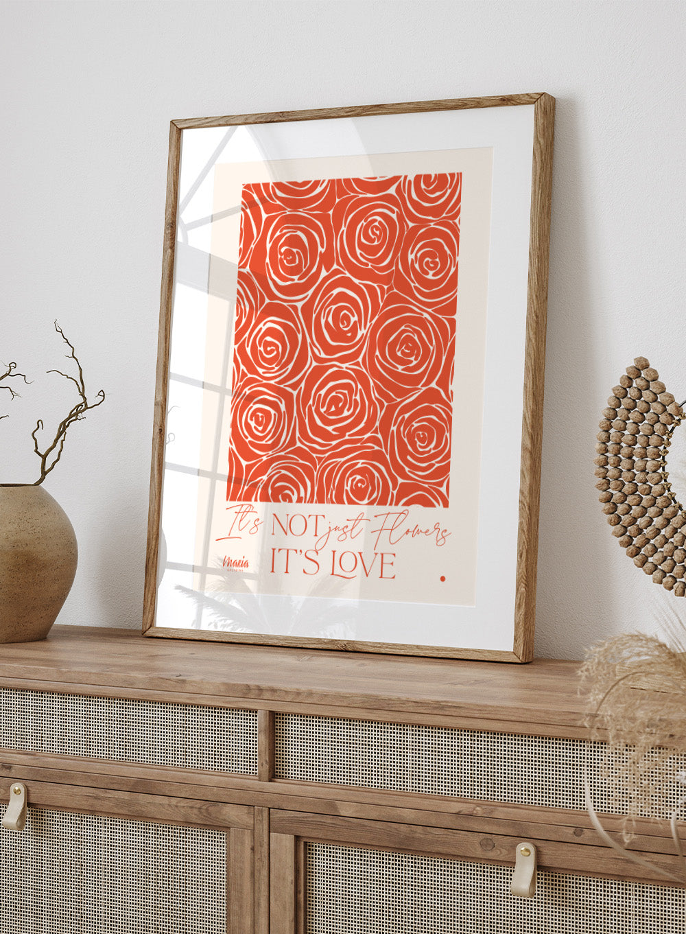 Pattern of red roses with text 'It's NOT just flowers IT'S LOVE' on a beige background. About Love. Smell of Roses by Maria Galybina is a floral art print with coral rose patterns and romantic typography. Modern love wall poster.