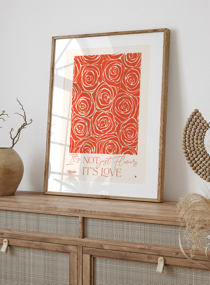 Pattern of red roses with text 'It's NOT just flowers IT'S LOVE' on a beige background. About Love. Smell of Roses by Maria Galybina is a floral art print with coral rose patterns and romantic typography. Modern love wall poster.
