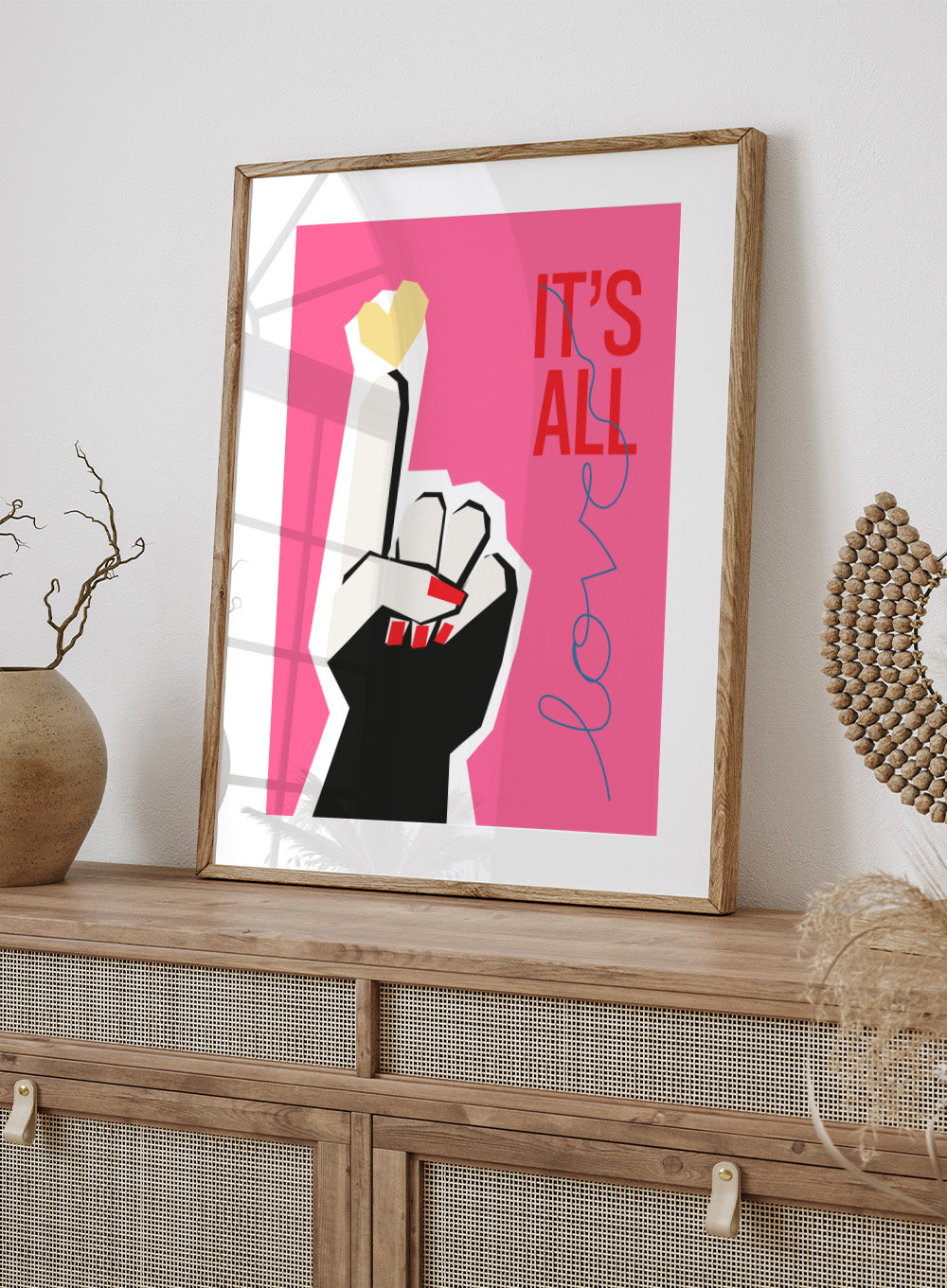 Illustration of a hand making a peace sign with text 'IT'S ALL LOVE' on a pink background. It’s All Love Hand Pink by Frances Collett is a modern graphic art print featuring an illustrated hand with heart symbol and bold typography. Officially licensed wall poster with optional framing.