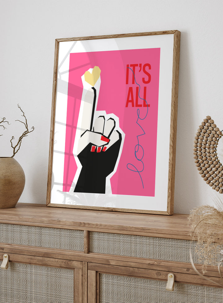 Illustration of a hand making a peace sign with text 'IT'S ALL LOVE' on a pink background. It’s All Love Hand Pink by Frances Collett is a modern graphic art print featuring an illustrated hand with heart symbol and bold typography. Officially licensed wall poster with optional framing.