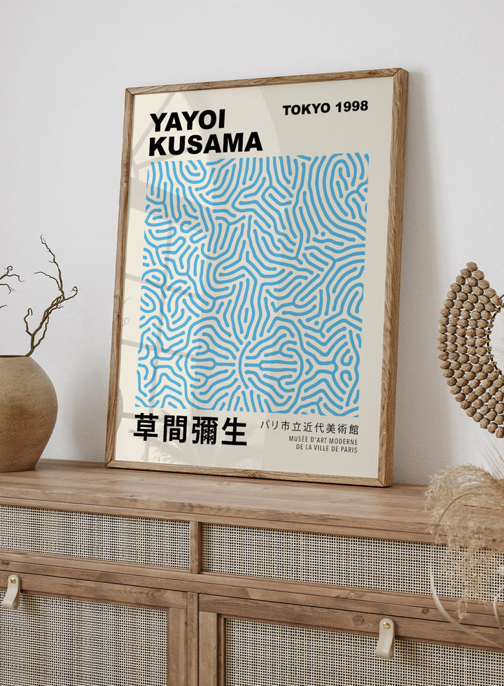 Inspired by Yayoi Kusama 草間彌生 Polka Dot Art, this exhibition Japanese poster art print showcases illustration of blue geometric lines against beige background. Featuring abstract geometric infinity web art, this Japani vintage exhibition poster by Yayoi Kusama is perfect for any boho, retro, minimalist, or Japani space.