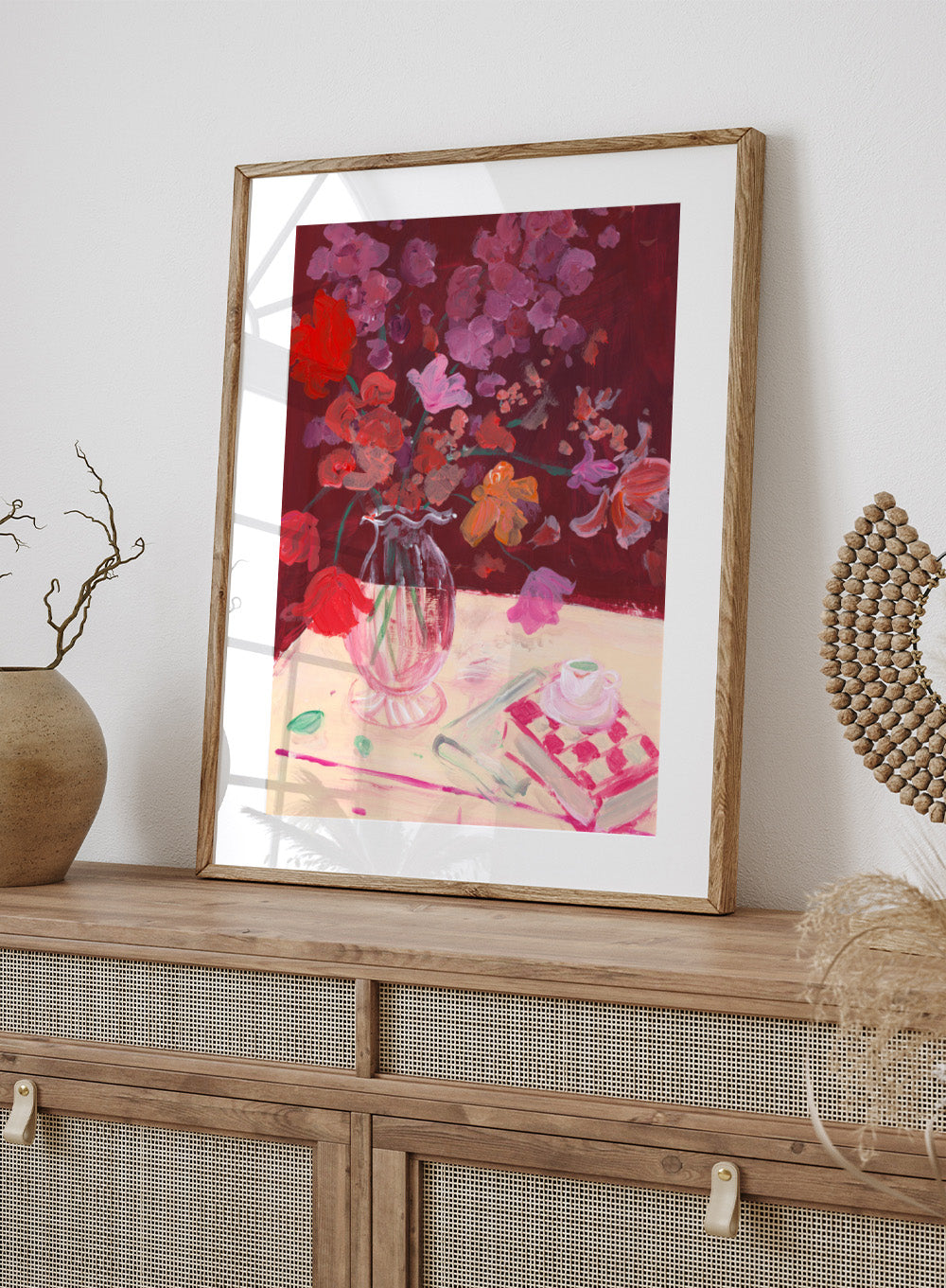 Colorful still life painting with flowers and a teacup on a table. Fall Bouquet by Katharina Puritscher art print featuring expressive floral still life, glass vase, coffee cup, book, and brushstrokes. Officially licensed wall poster.