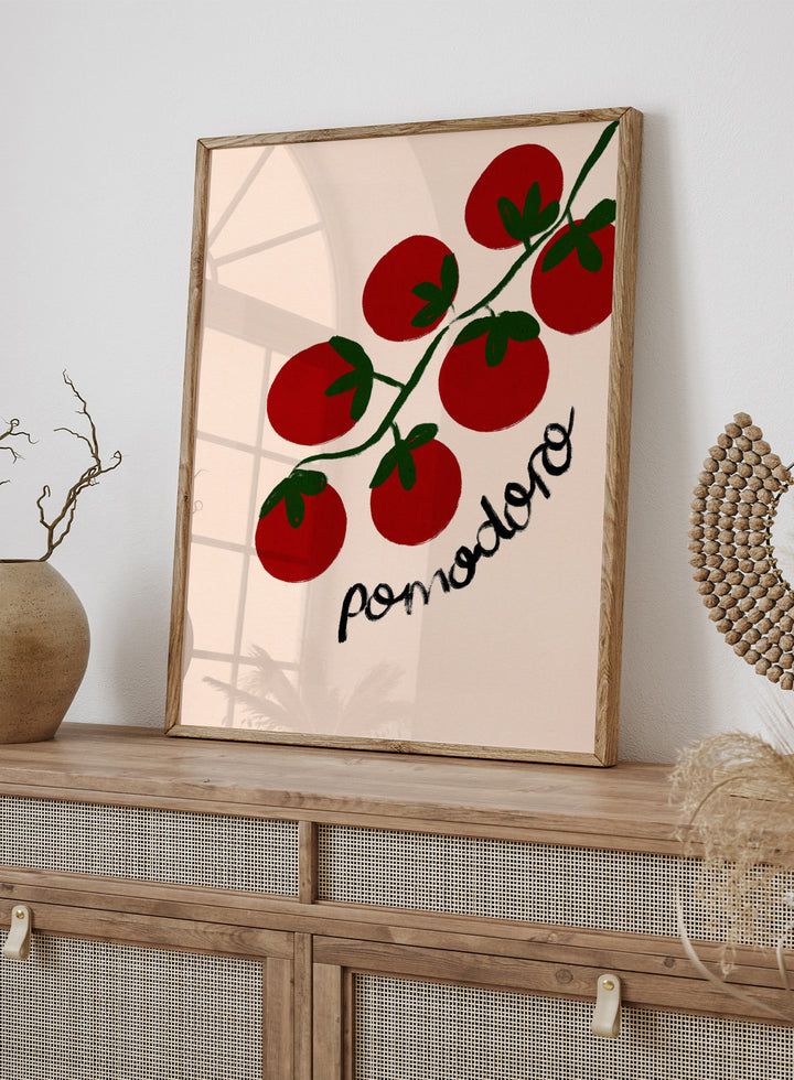 Illustration of red tomatoes on a branch with ' pomodoro' text on a beige background. Italian Pomodoro Tomatoes by Dirkie Nell is a contemporary food art print featuring hand painted red tomatoes, playful typography, and colorful Mediterranean inspired style.