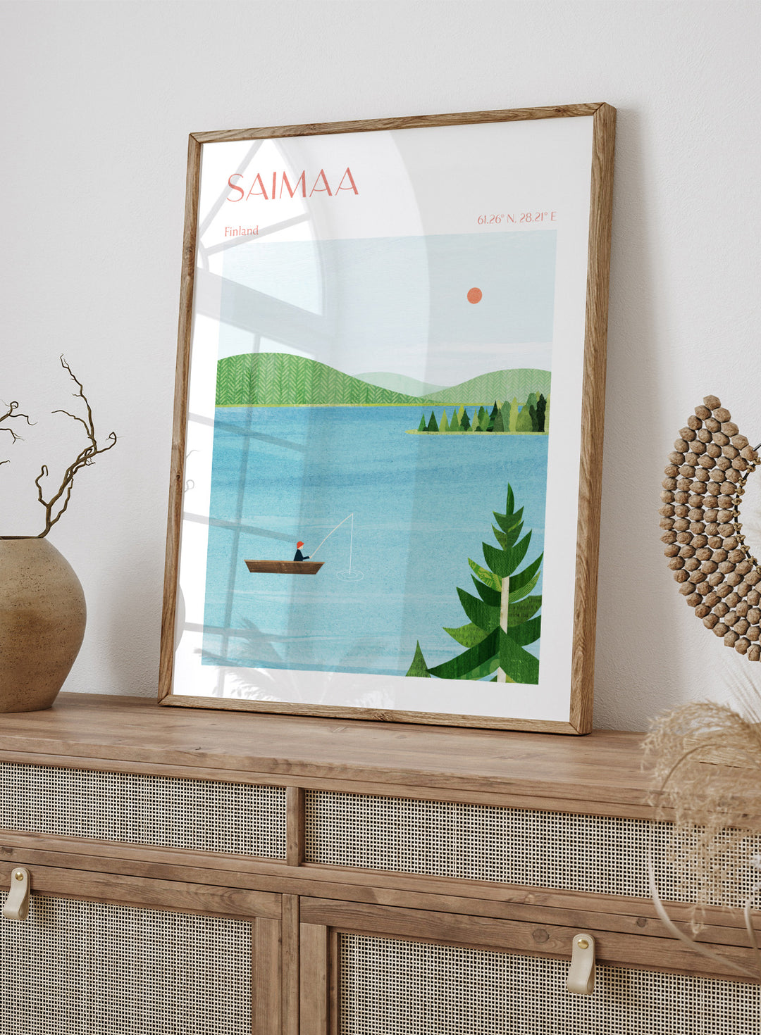 Illustration of a lake scene with a person fishing, surrounded by greenery and mountains, with 'Saimaa, Finland' text at the top. Calm Saimaa Lake Fishing by Longwayhome is a minimalist Scandinavian landscape art print featuring peaceful Finland lake scenery, forest views, and modern Nordic design.