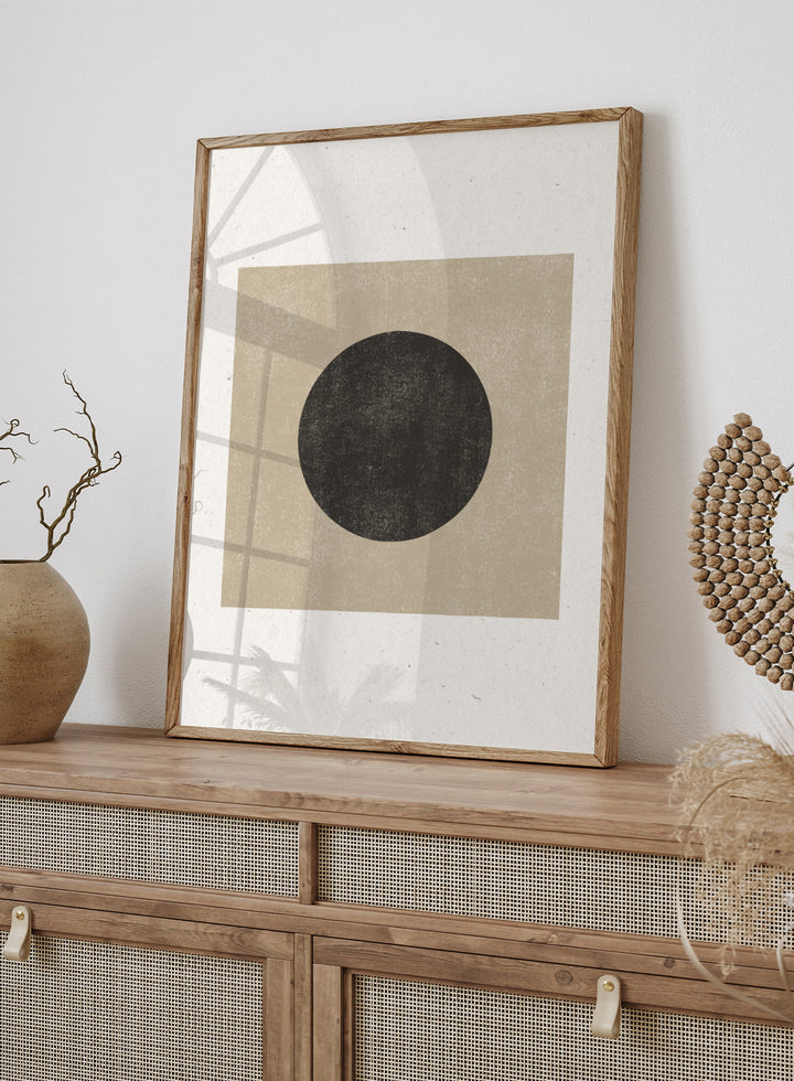 Black circle on beige background. Eclipse Silence by The MIUUS Studio is a minimalist abstract art print and wall poster featuring geometric shapes, neutral tones, and modern textured design.