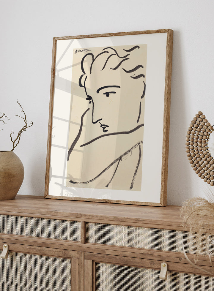 Artistic line drawing of a profiled face on beige paper. Profil de femme by Henri Matisse is a minimalist portrait art print featuring expressive black linework, modern French design, and elegant abstract simplicity.