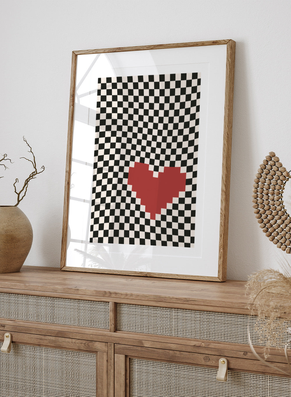 Checkered pattern with a red heart in the center. Pixel Heart by Frankie Kerr-Dineen features a red pixel heart on a wavy checkerboard background. Modern graphic art print and contemporary wall poster.