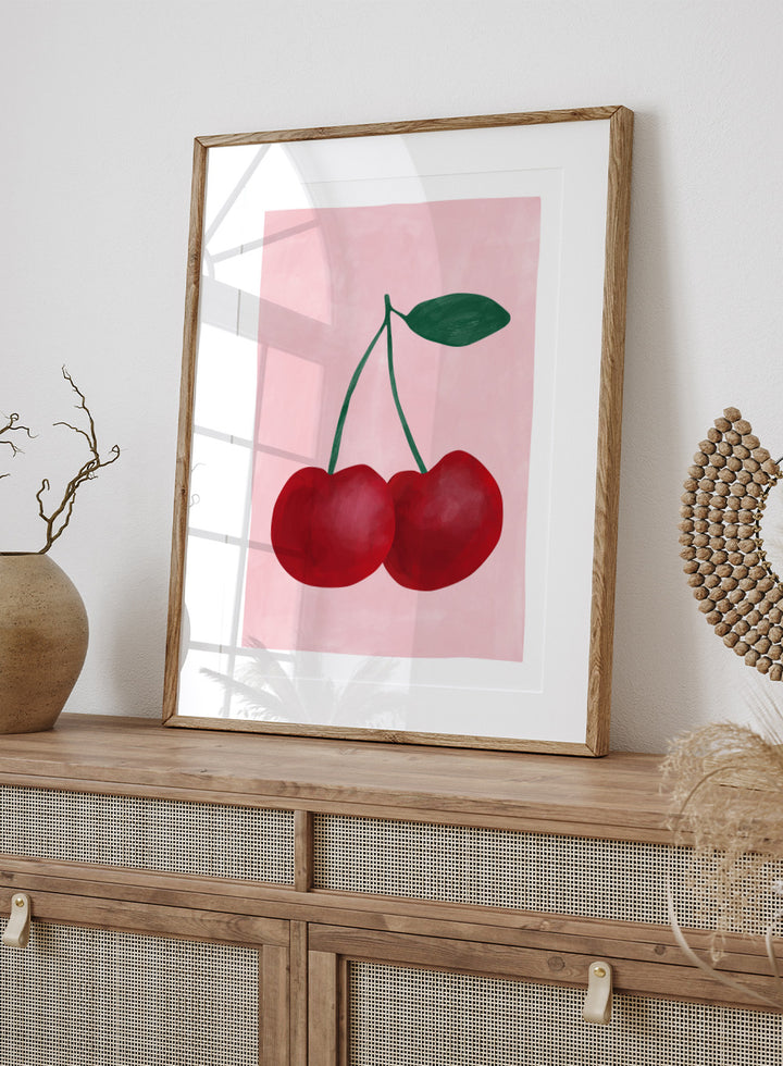 Two red cherries with a green stem on a pink background. Red cherries art print by Elena Ristova featuring two hand-painted cherries with green stems on a soft pink background. Officially licensed minimalist wall poster.