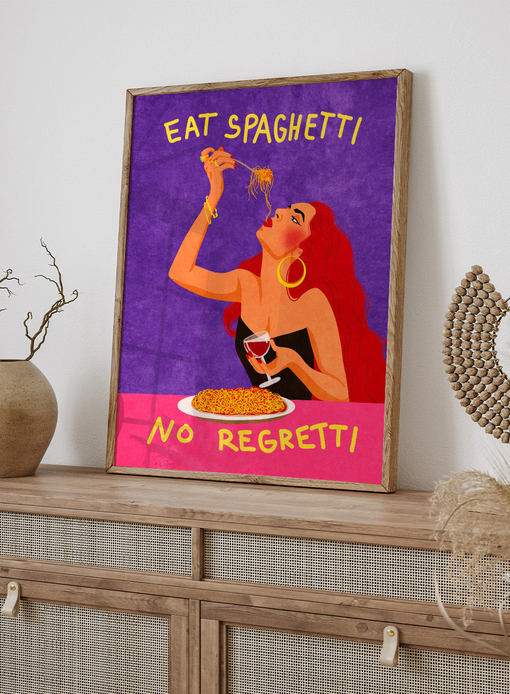Illustration of a woman eating spaghetti with text 'Eat Spaghetti No Regretti' on a purple and pink background. Eat Spaghetti No Regretti by Raissa Oltmanns is a modern kitchen art print featuring a woman eating pasta, wine illustration, and funny food wall poster.