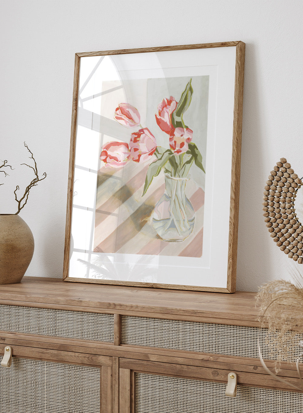 Artistic depiction of pink tulips in a clear vase on a striped background. Tulips in a Vase by Lucrecia Caporale is an officially licensed still life art print featuring pink tulips in a glass vase. Available framed or unframed.