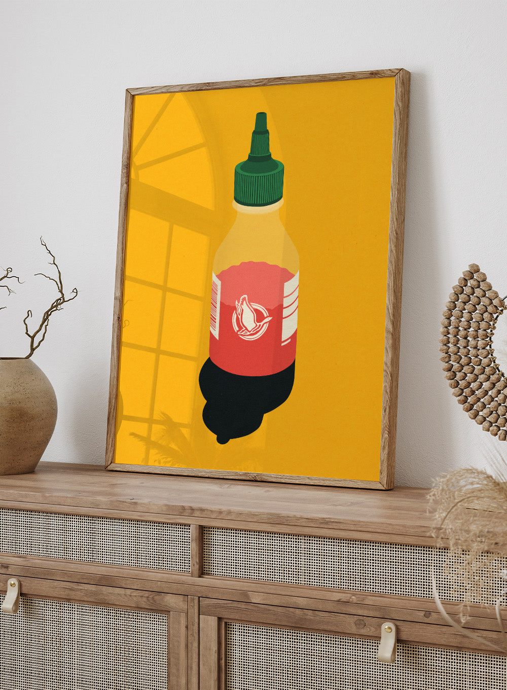 Chilli sauce bottle illustration on a yellow background. Chilli Sauce by Rosi Feist is a bold kitchen art print featuring a hot sauce bottle in modern graphic style. Contemporary food poster wall art.