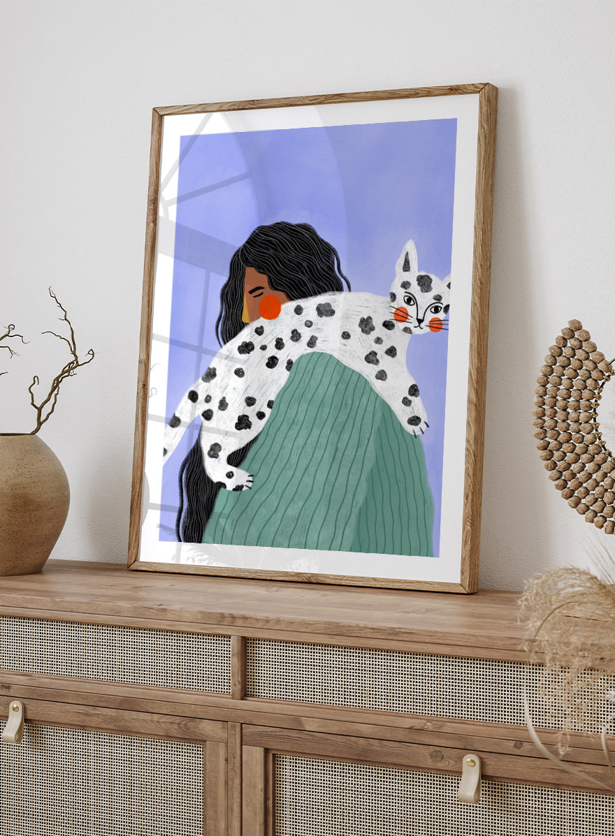 A framed art print featuring a stylized illustration of a woman with long black hair carrying a white cat with black spots over her shoulder, set against a lavender background. Woman and Spotted Cat by Bea Müller animal art print featuring a woman carrying a playful spotted cat, perfect for modern cat lover and pet decor.