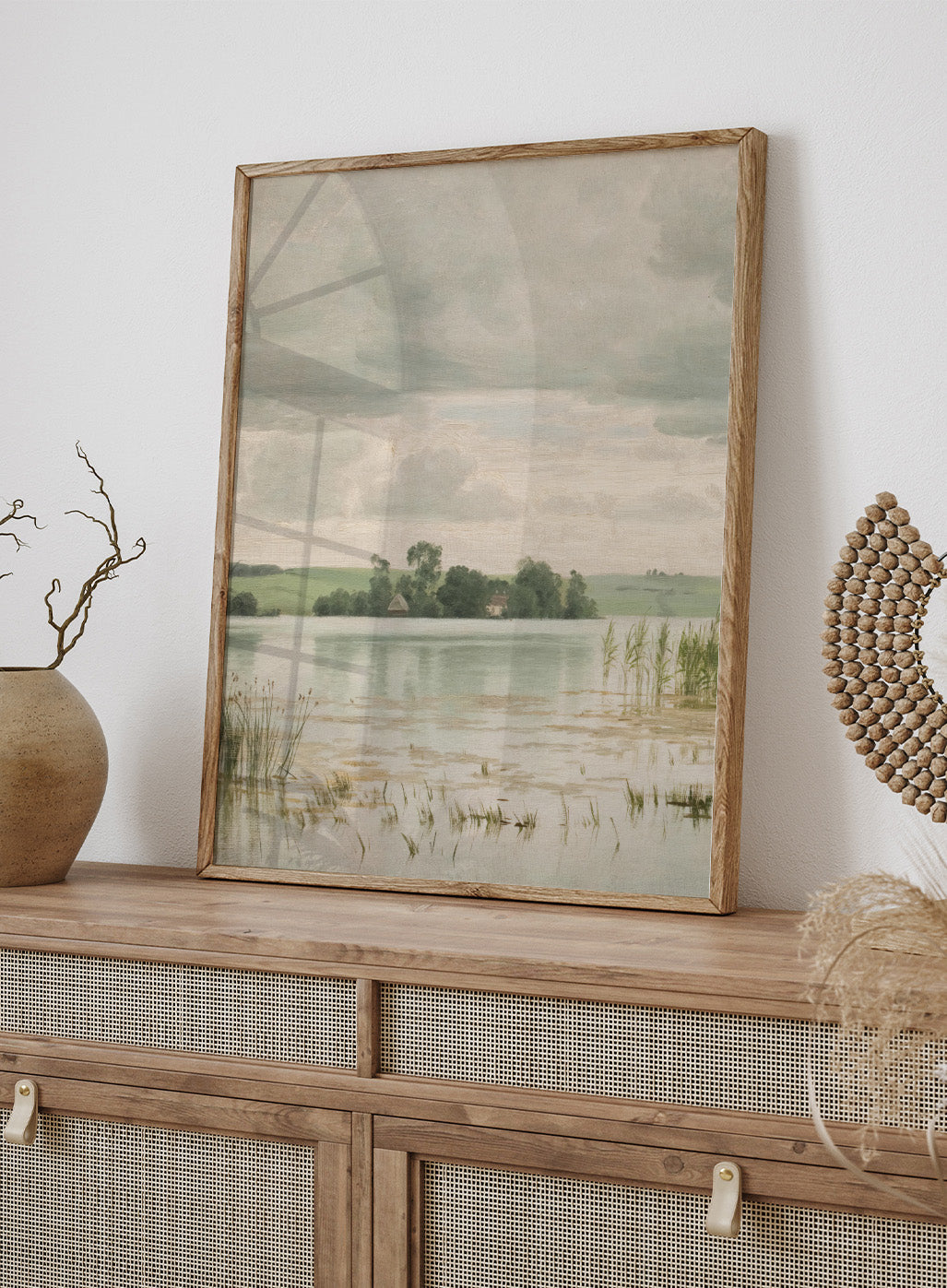Featuring the original Vilhelm Groth's Artwork Esrom sø (Esrum Lake), this dark moody European vintage neutral autumn river lake landscape oil painting wall art print showcases a classic rustic moody antique style that is perfect for any boho or modern farmhouse space with muted or neutral fall colors. 