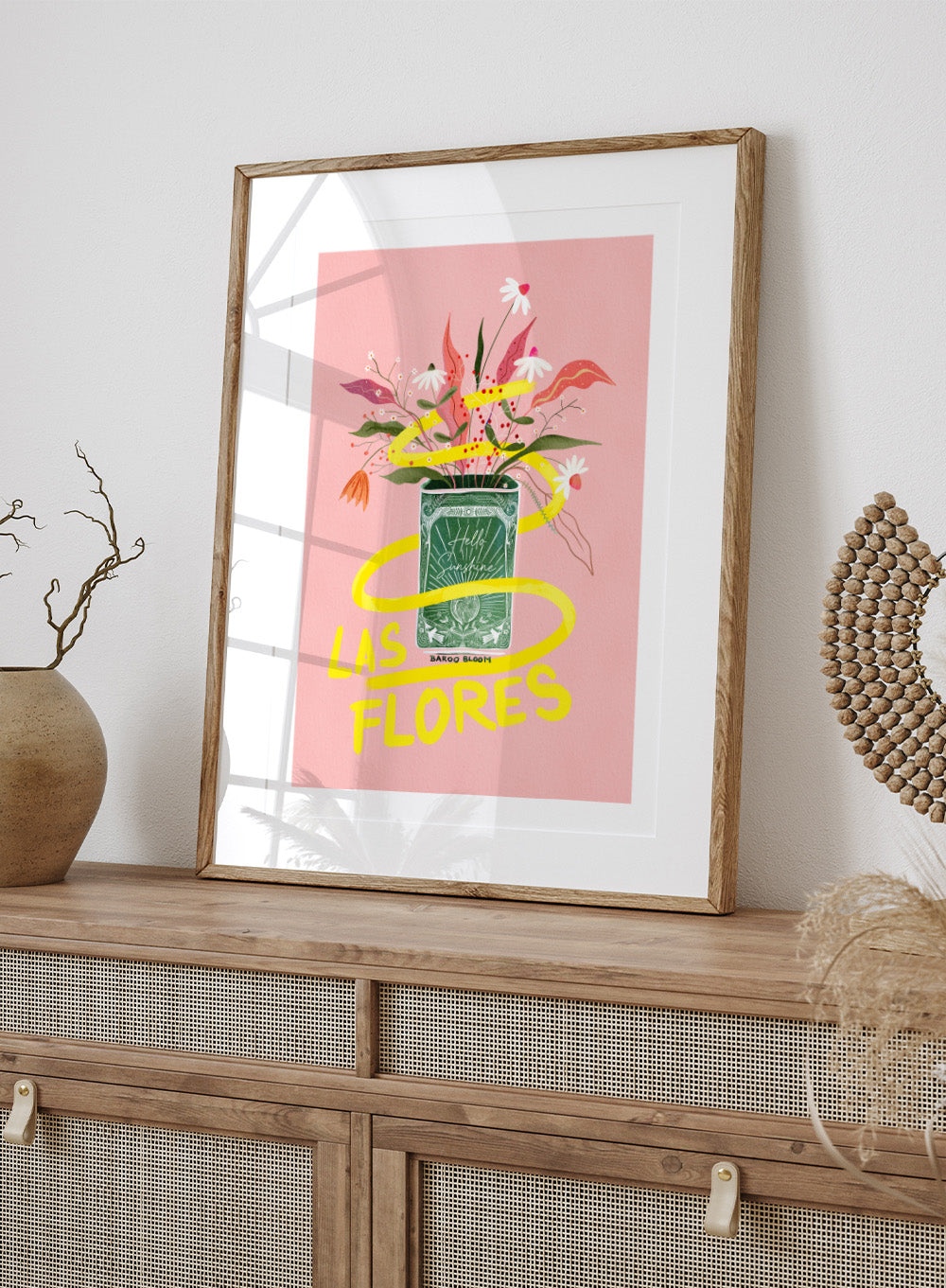 Illustration of a flower arrangement in a can with 'Las Flores' text on a pink background. Las Flores by Baroo Bloom is a colorful floral art print with playful illustration and bold lettering. Officially licensed wall poster with optional framing.