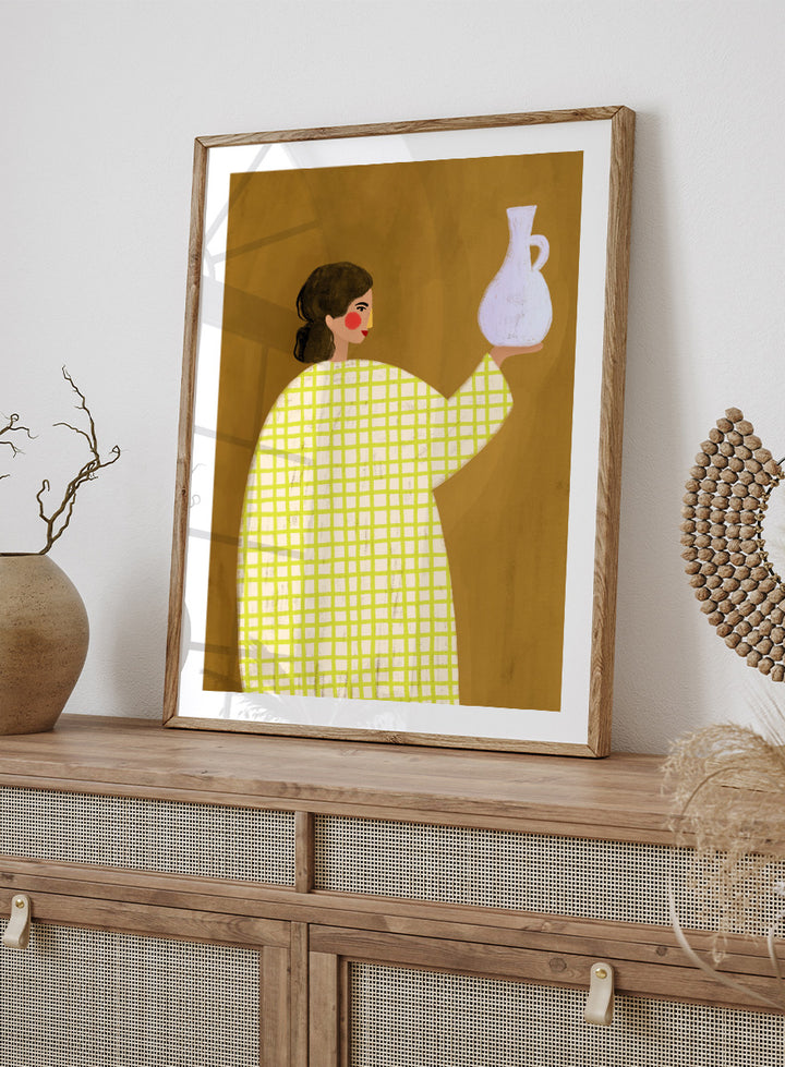 A framed art print featuring a stylized illustration of a woman in a yellow and white checkered dress holding a white jug against a warm brown background. Woman Holding Pottery by Bea Müller art print featuring a woman with a white ceramic jug, bold green checks, and warm mustard tones for modern decor.