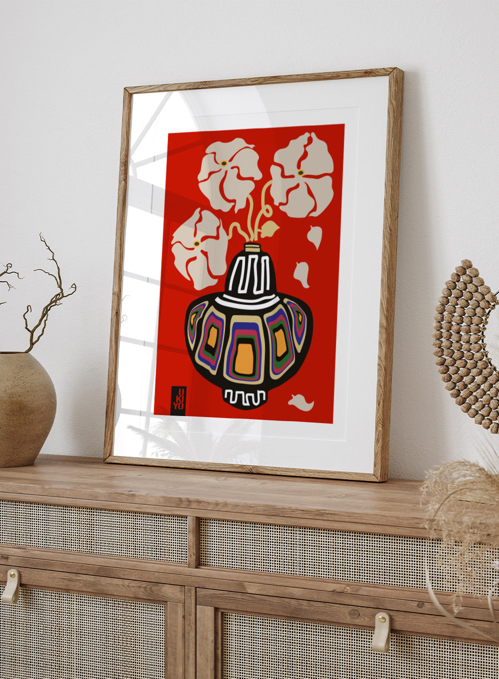 Decorative vase with colorful patterns on a red background. Ukiyo Vase Flower Rainbow Red by Frances Collett art print featuring a colorful patterned vase with cream flowers on a red background. Officially licensed wall poster with optional framing.