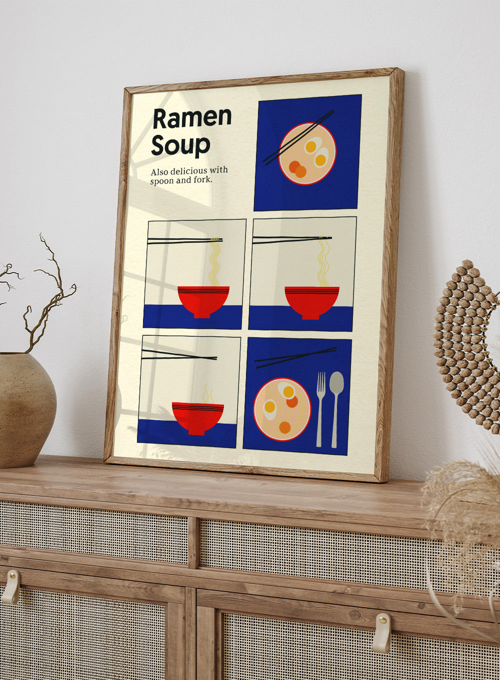 Illustration of ramen soup with chopsticks, a spoon, and fork on a blue background. Ramen Soup by Rosi Feist is a minimalist ramen art print with bold Bauhaus color, chopsticks, and playful humor. Officially licensed modern food poster.