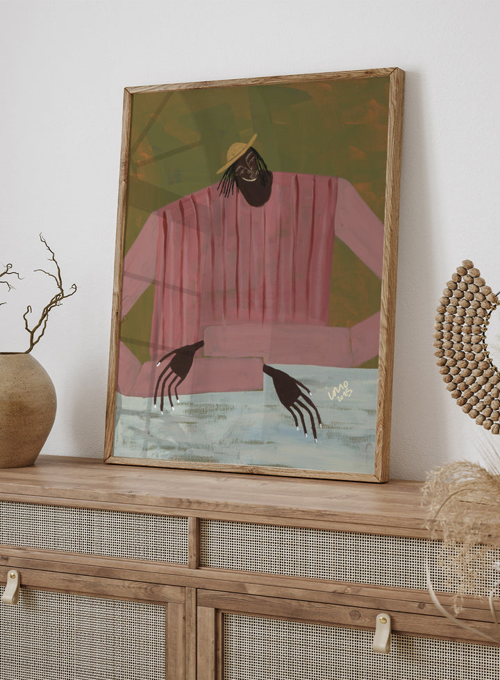 Artistic depiction of a person wearing a pink shirt and straw hat on a textured background. For Now I Don’t Know by Studio IMO (Ibi Meier-Oruitemeka) is a modern figurative art print with a seated figure and contemporary portrait wall poster design.