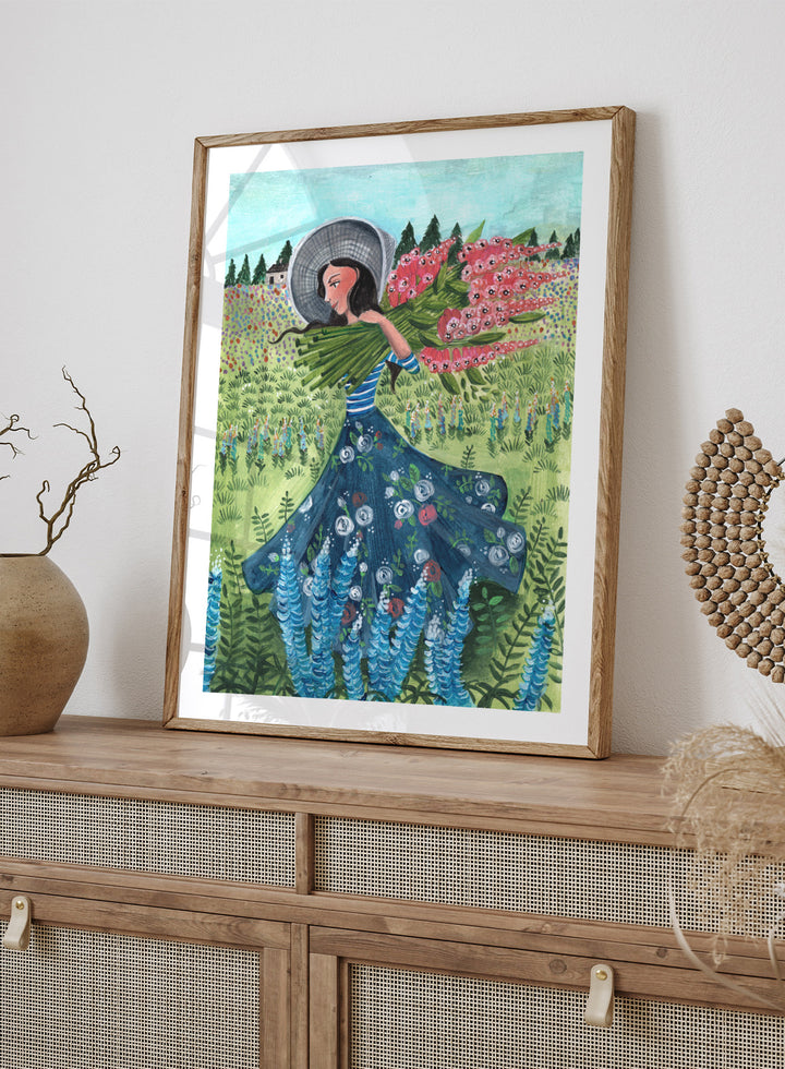 Woman in a floral dress holding flowers in a garden. Woman With Summer Flowers by Caroline Bonne Müller is a fine art print and wall poster featuring a woman carrying flowers through a colorful field.