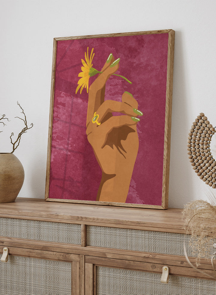 Illustration of a hand holding a yellow flower against a pink background. Smoking Flower by Raissa Oltmanns is a modern floral art print featuring a hand holding a yellow flower in bold contemporary wall poster style.