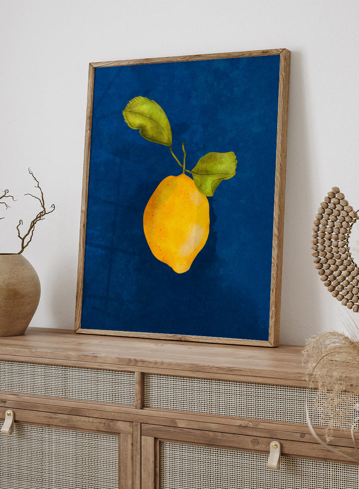 Just a Little Lemon by Raissa Oltmanns is a modern lemon art print featuring a bold yellow citrus still life on deep blue wall poster design.