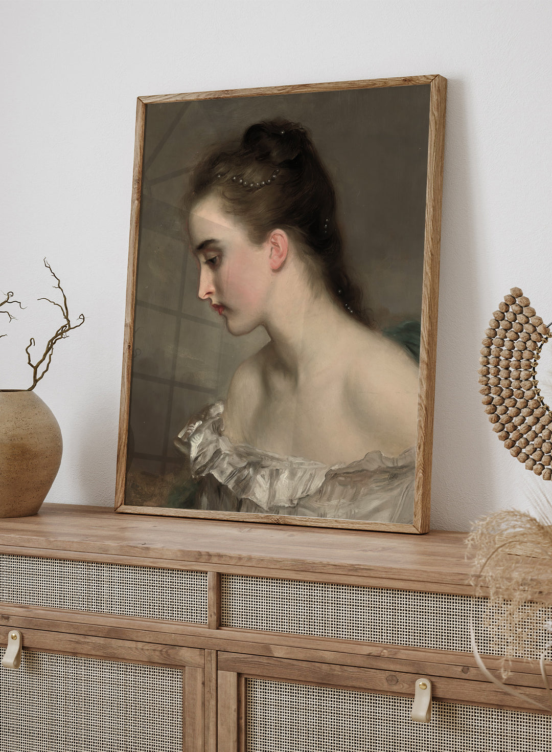 The Debutant by Gustave Jean Jacquet is a vintage portrait print of a young woman in profile with pearls in her hair and a white ruffled dress.