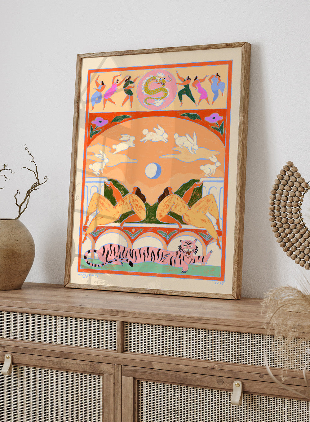 Decorative artwork with animals and people in a stylized setting. Rabbit Jumps Over the Moon by Arty Guava is a surreal art print with rabbits, dancers, and a tiger in bold color. Officially licensed wall poster.