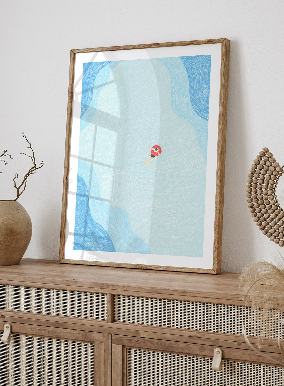 Calm Summer Swim by Rio Soléy is a minimalist coastal art print featuring a lone swimmer, soft blue water, playful illustration, and relaxed summer vibes.