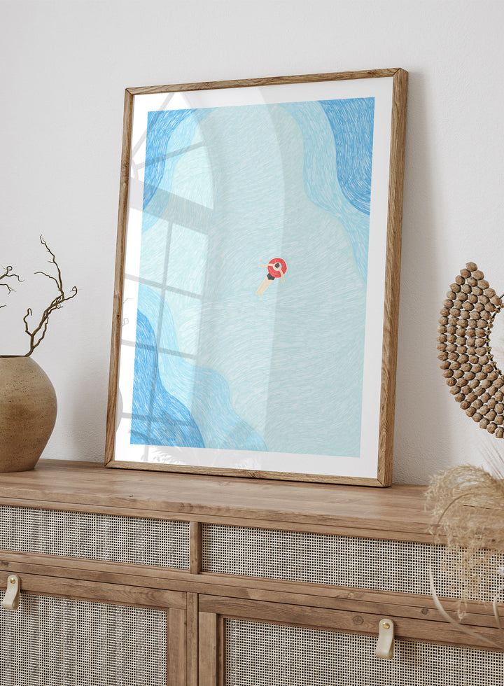 Calm Summer Swim by Rio Soléy is a minimalist coastal art print featuring a lone swimmer, soft blue water, playful illustration, and relaxed summer vibes.