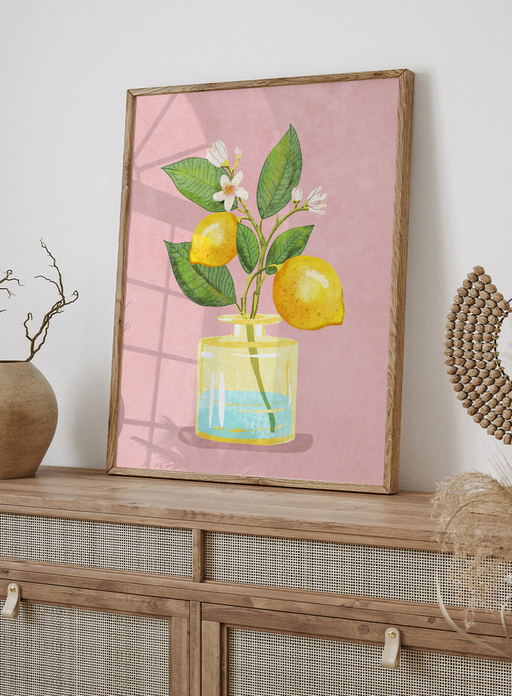 Illustration of lemons and a flower in a glass bottle on a pink background. Lemon Bunch In Vase by Raissa Oltmanns is a modern lemon still life art print featuring citrus fruit and floral kitchen wall poster design.