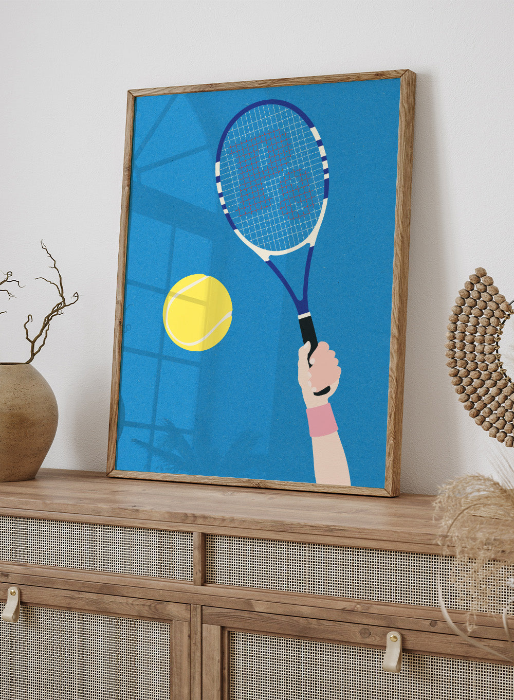 Tennis racket and ball on a blue background. Perfect Serve by Rosi Feist is a modern minimalist tennis art print featuring bold graphic color, clean lines, and Bauhaus-inspired design. Officially licensed fine art poster with framing.