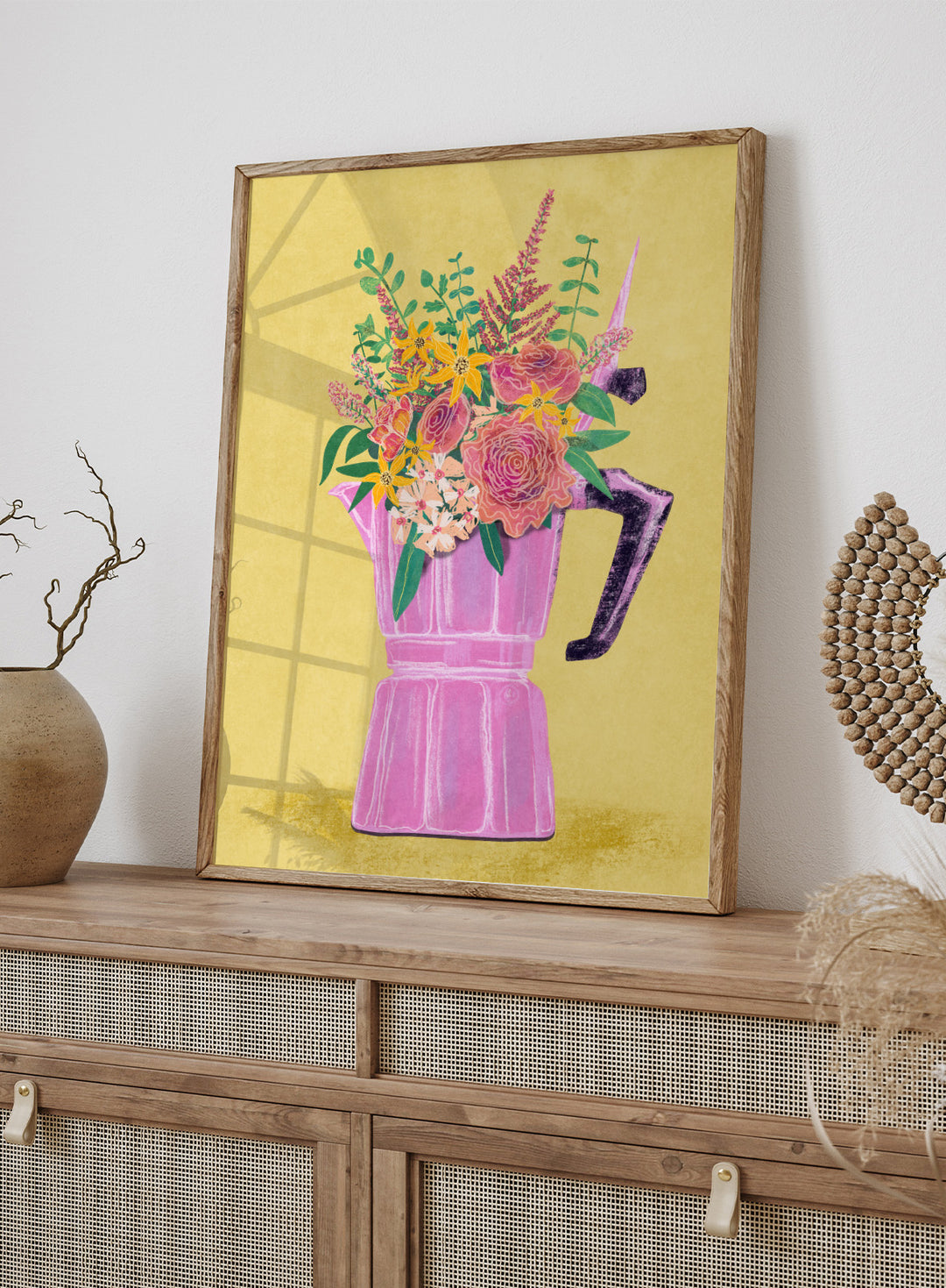 Colorful floral arrangement in a pink vase on a yellow background. Espresso Maker with Flowers by Raissa Oltmanns is a modern floral fine art print featuring a pink moka pot vase still life and bold kitchen wall decor poster.