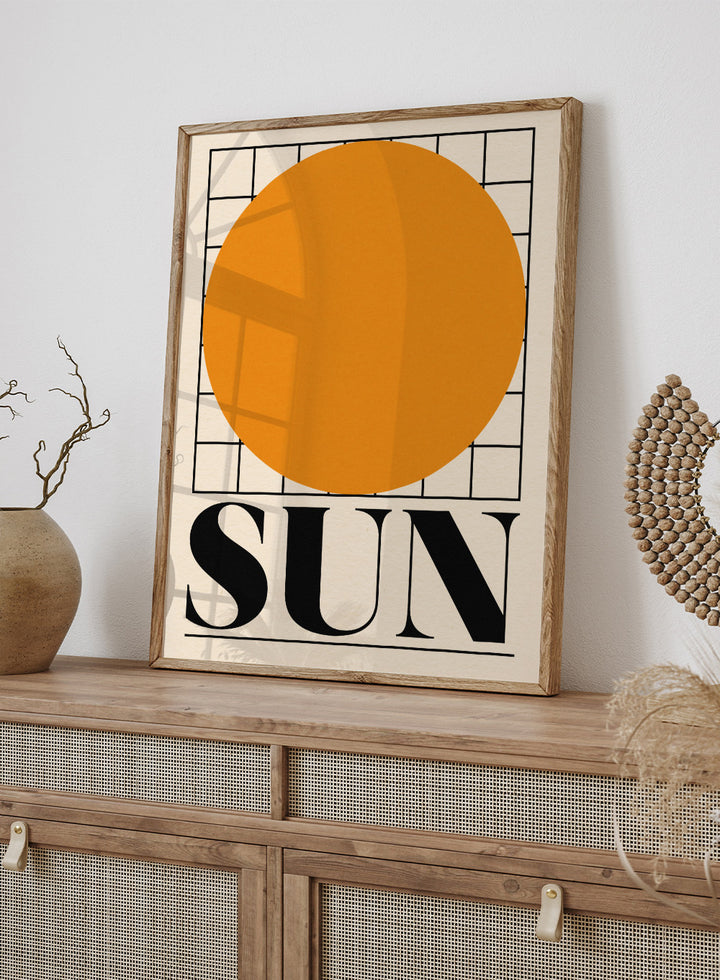 Poster with a large orange circle and the word 'SUN' on a beige background. Sun by Rosi Feist is a bold minimalist Bauhaus-inspired art print featuring an orange circle and graphic grid. Officially licensed modern poster with framing.
