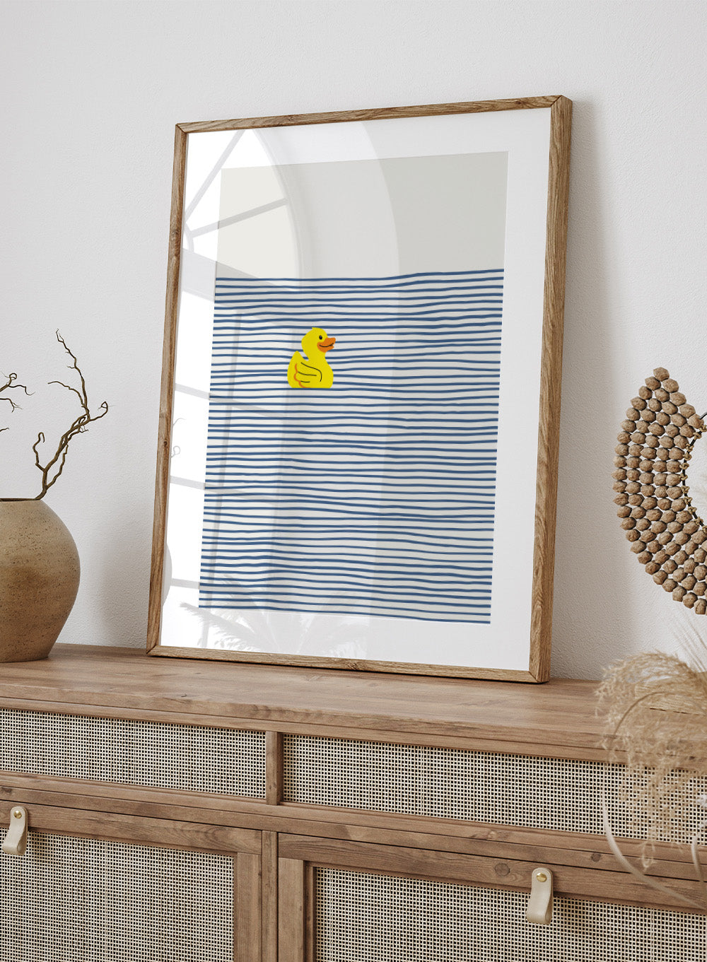 Yellow Duck Afloat art print by Little Dean. Playful duck illustration with blue ocean stripes, modern minimalist wall art, contemporary poster design.