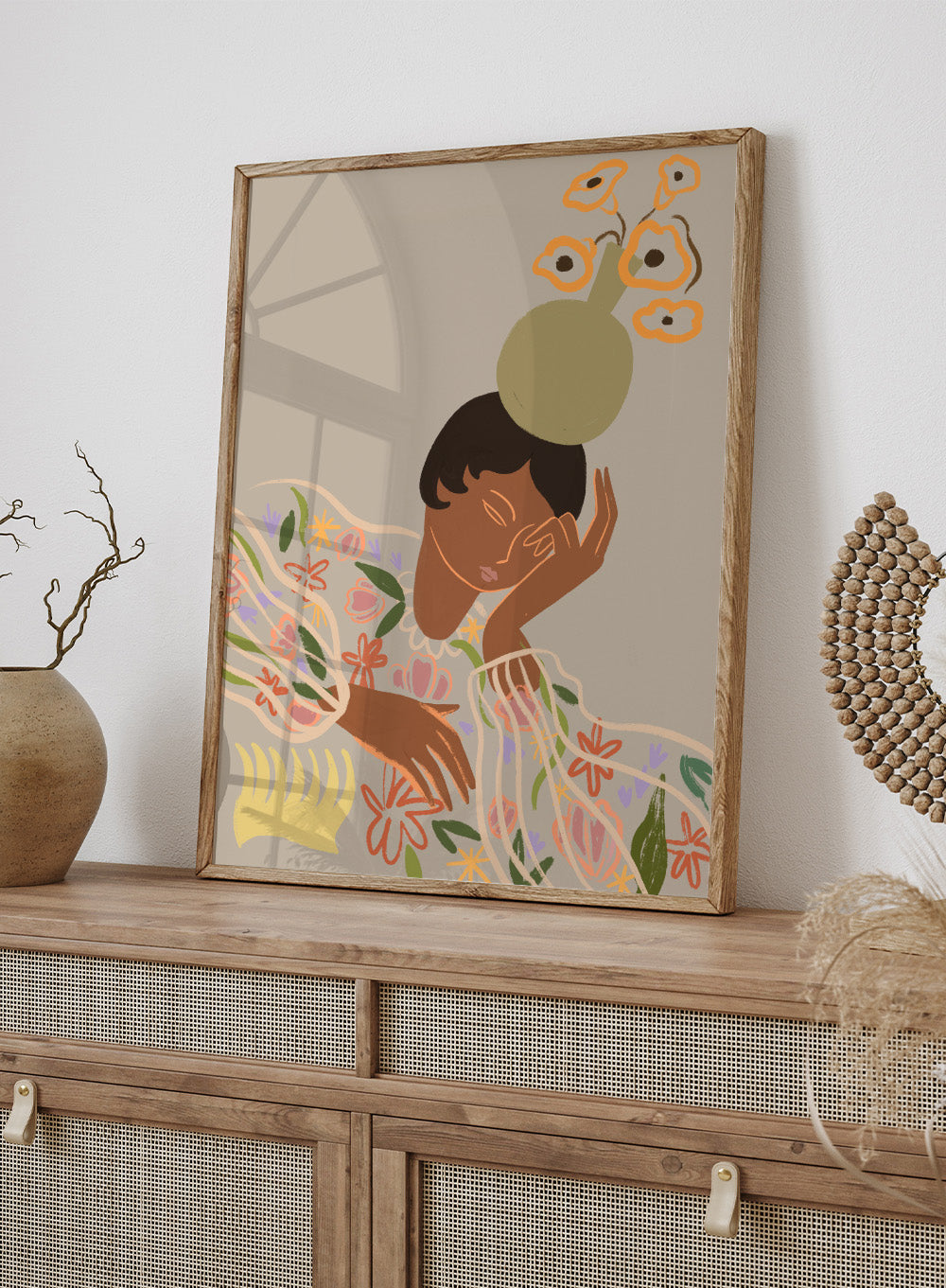Illustration of a person with a flower on their head against a beige background. The Overthinker by Arty Guava is a modern woman illustration art print with soft florals and warm tones. Officially licensed wall poster with framing.