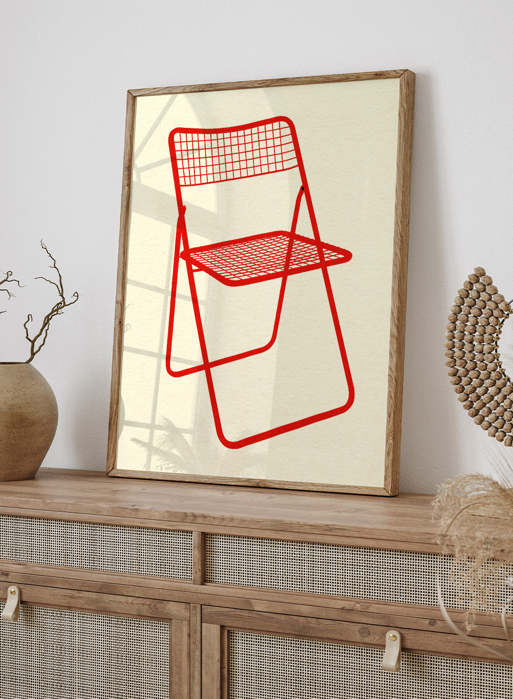 Red metal chair on a beige background. Modern chair wall art print by Rosi Feist featuring a bold red wire net chair illustration. Contemporary minimalist poster for design lovers.