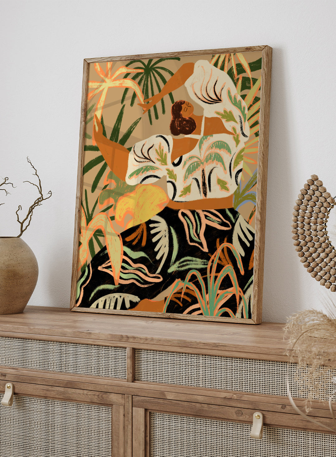 Artistic depiction of a woman in a floral dress with tropical plants in the background. Nature Embrace by Arty Guava art print featuring woman surrounded by tropical plants, flowing botanical illustration, and warm contemporary nature wall art poster.