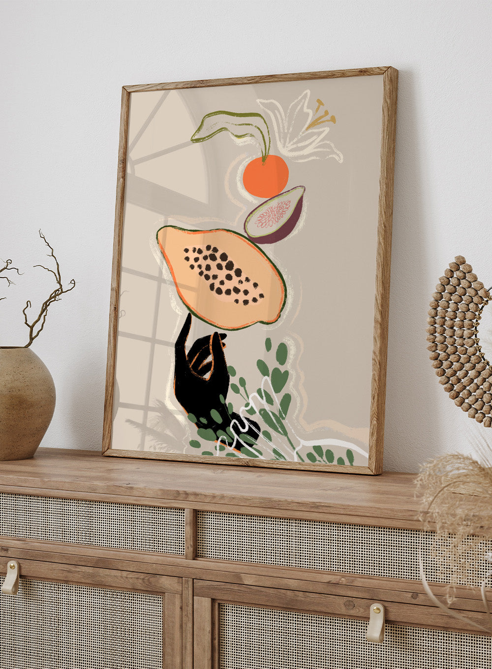 Illustration of a sloth holding a papaya with a beige background. Balancing Fruits by Arty Guava is a modern fruit still life art print with papaya and fig. Officially licensed wall poster for kitchen decor.