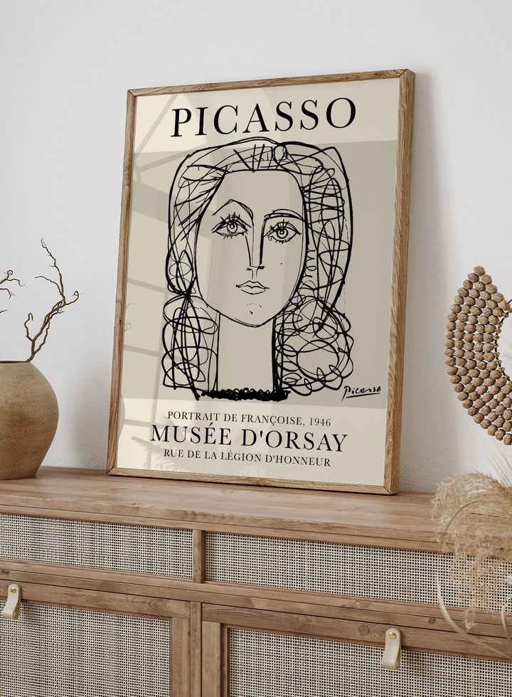Inspired by Pablo Picasso's original line drawing artwork, this signed lithograph wall art print showcases a portrait of Francoise Gilot 1946 (Portrait de Françoise) in one line art against a white background. This vintage museum exhibition poster by Musee D'orsay is perfect for any boho, retro, or minimalist space.