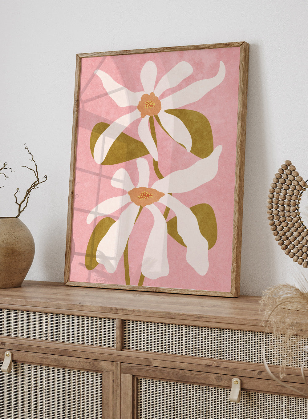 Two white flowers with green stems on a pink background. Abstract Flowers I by Raissa Oltmanns is a modern floral art print featuring white blooms on pink in contemporary botanical wall poster style.