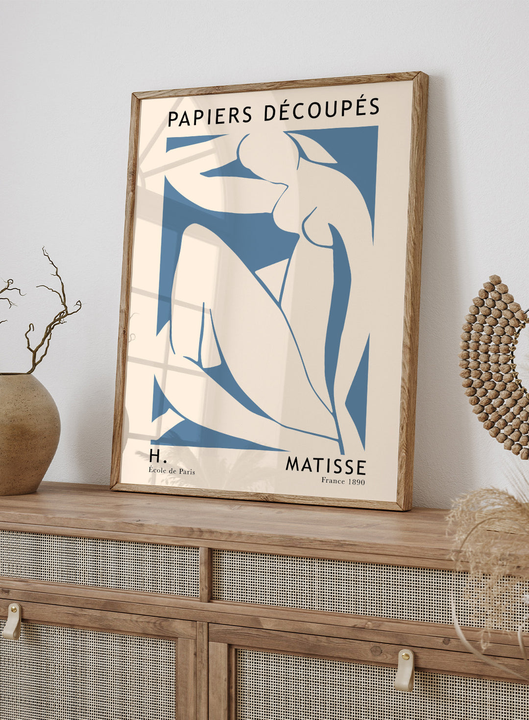 Inspired by Henri Matisse's Artwork The Blue Nudes II 1952, this lithograph wall art print showcases illustration of sitting nude figure against blue background. Featuring abstract graphics and text, this Papiers Découpés vintage exhibition poster by MoMa is perfect for any boho, eclectic, retro, or minimalist space.