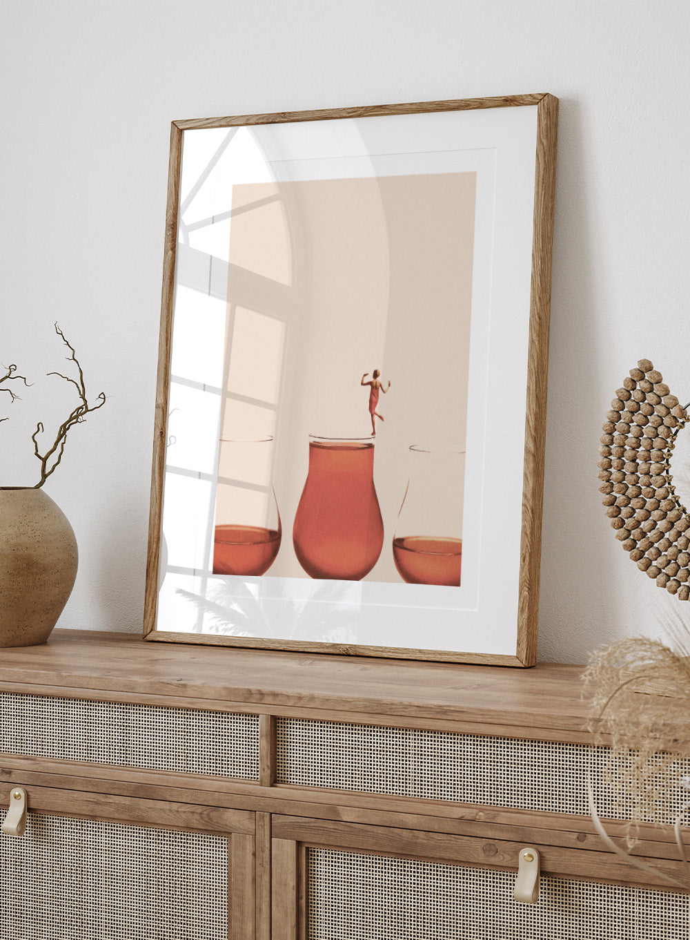 I Prefer the Full One by Maarten Léon collage art print featuring a woman standing on a full glass. Premium fine art print with real wood framing.