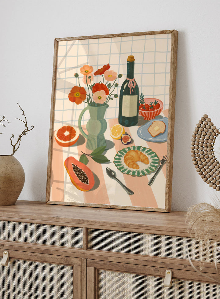 A stylized still life illustration showing a bottle, flowers in a pitcher, fruit, bread, and tableware on a striped surface against a grid background. Colorful Breakfast Still Life by Katarzyna Gąsiorowska art print featuring fruit, flowers, a croissant, and colorful kitchen tableware in soft modern tones.