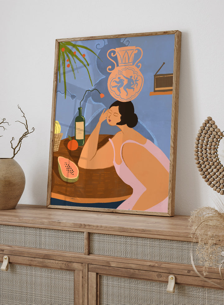 Illustration of a woman sitting at a table with a bottle, fruit, and decorative vase in a room. Bestill by Arty Guava is a colorful figurative art print featuring whimsical storytelling, playful symbolism, everyday objects, and contemporary wall art.