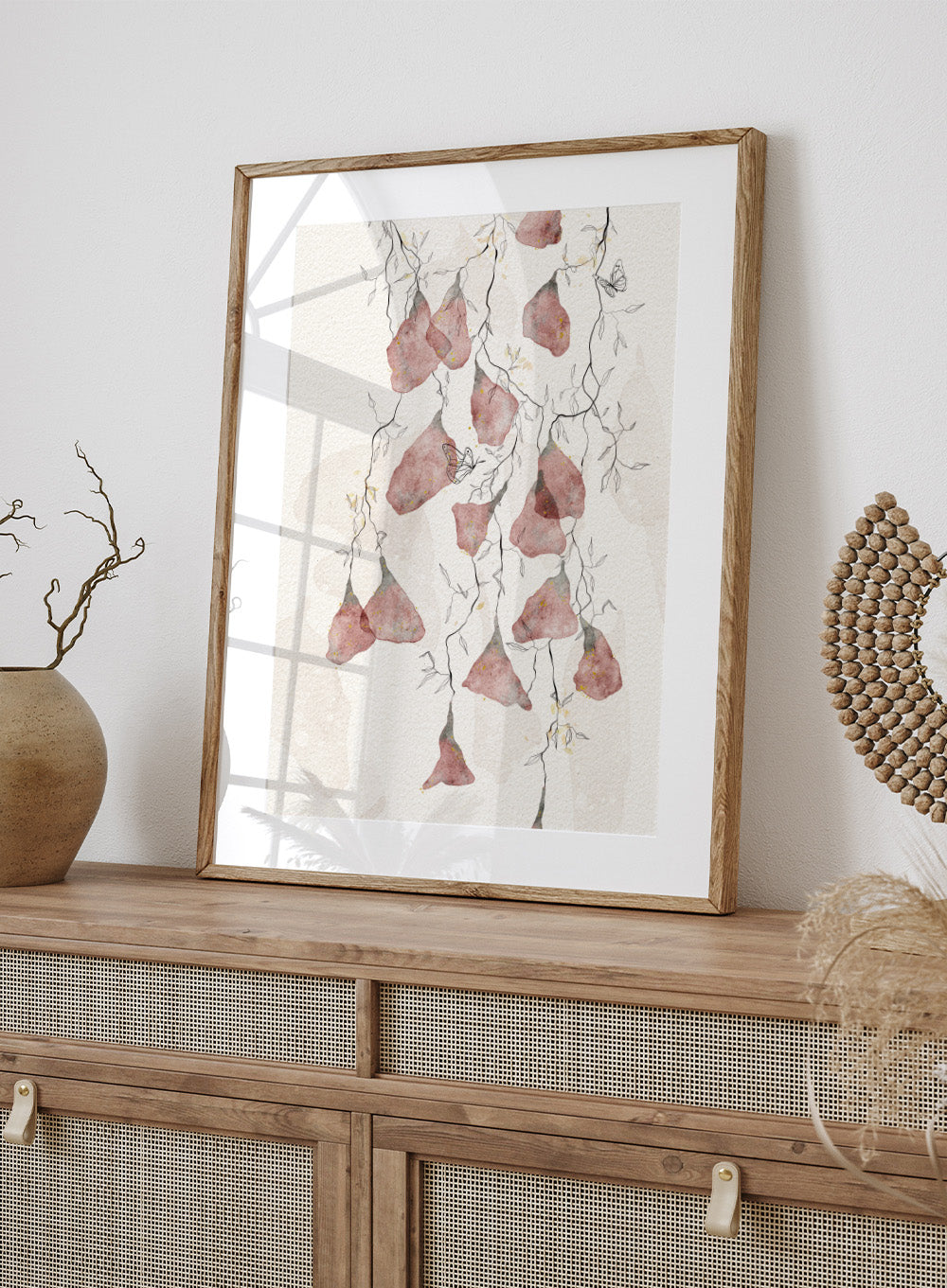 Artistic depiction of pink flowers and branches on a light background. Butterfly Kisses by Ankie Kooi features hanging watercolor flowers, delicate branches, and butterflies in soft neutral tones. Minimal botanical art print inspired by nature.