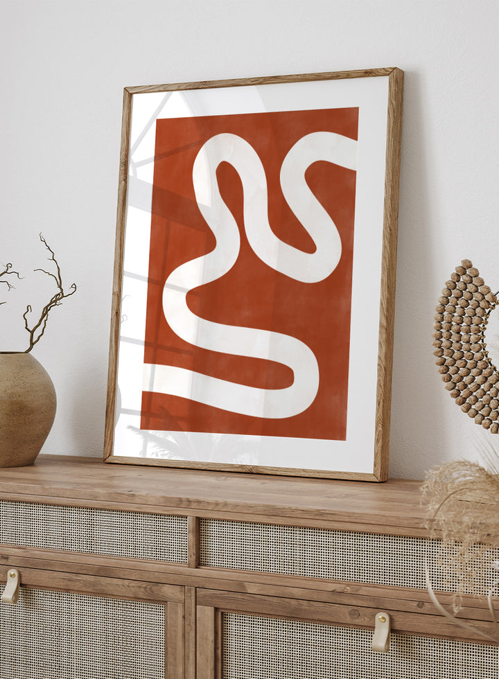 White wavy line on a red background. Crimson Pathways art print by Elena Ristova featuring a flowing white abstract line on a rust red background. Officially licensed modern abstract wall poster.