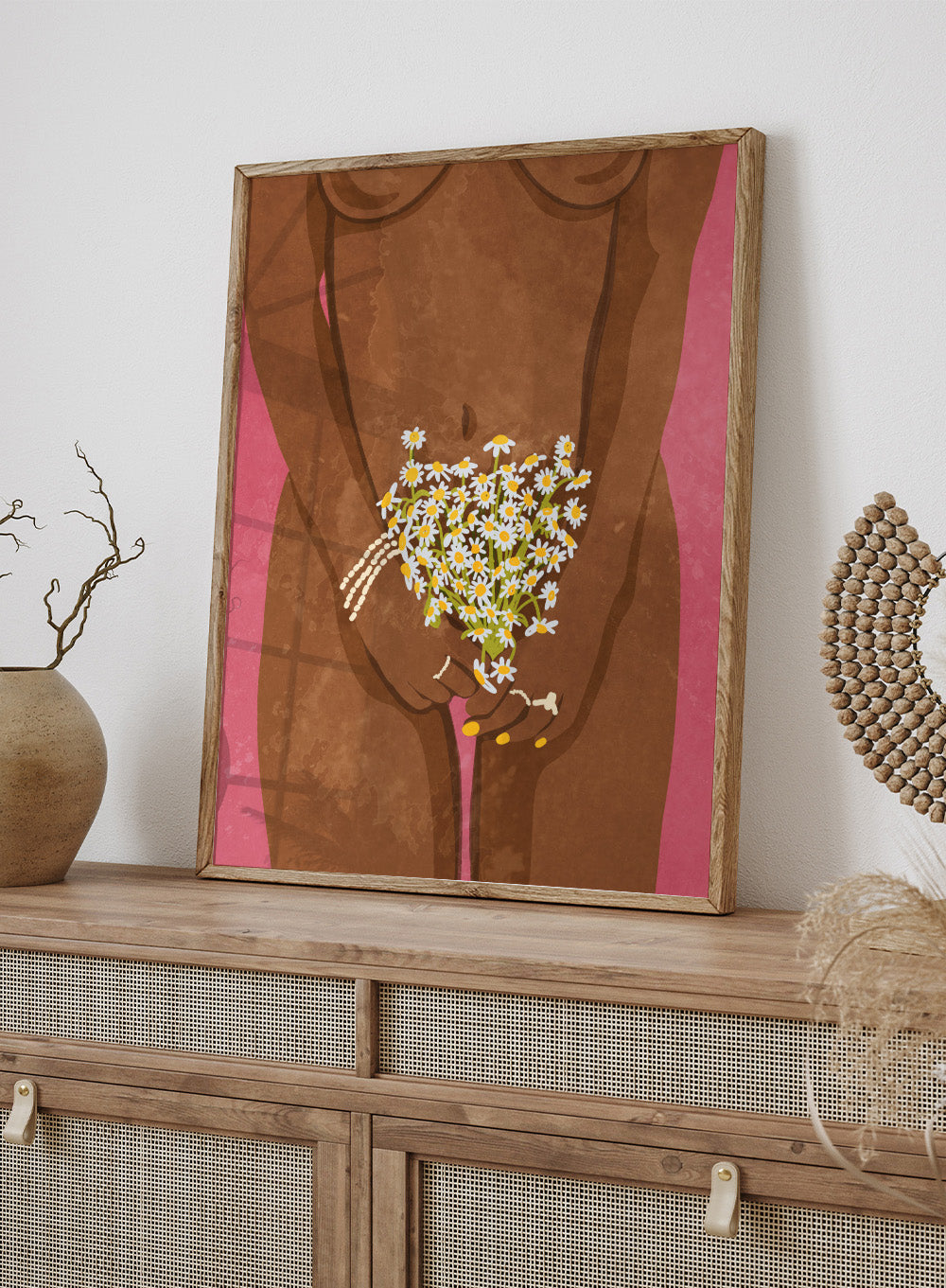 Illustration of a hand holding flowers against a brown background. Wearing Flowers by Raissa Oltmanns is a modern woman portrait art print with daisies, pink background, and minimalist graphic wall poster design.