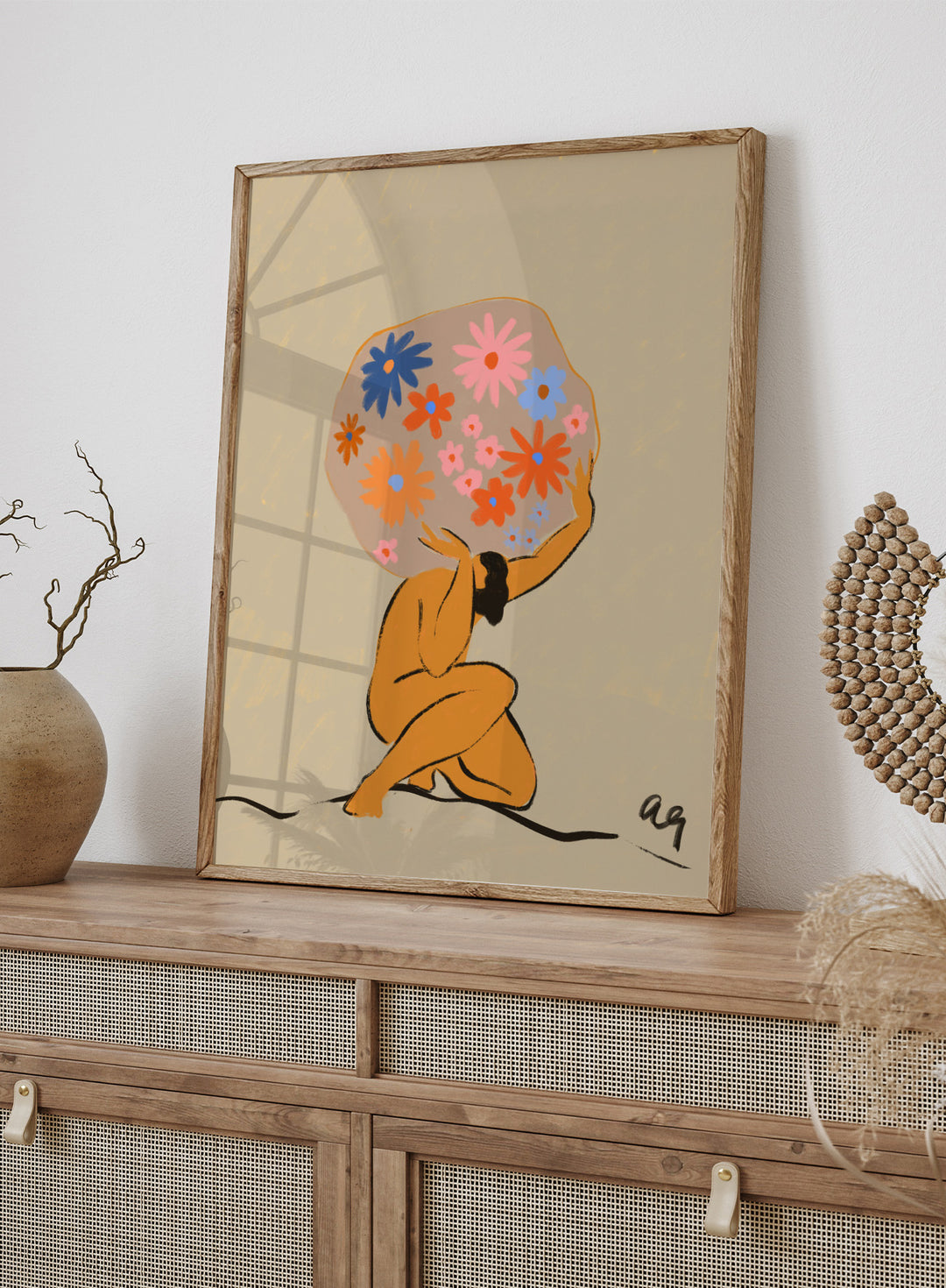 Surreal artwork of a figure holding a globe filled with colorful flowers on a beige background. World On Her Shoulders by Arty Guava is a colorful contemporary art print featuring a floral globe, expressive female figure, empowerment, and modern illustration.