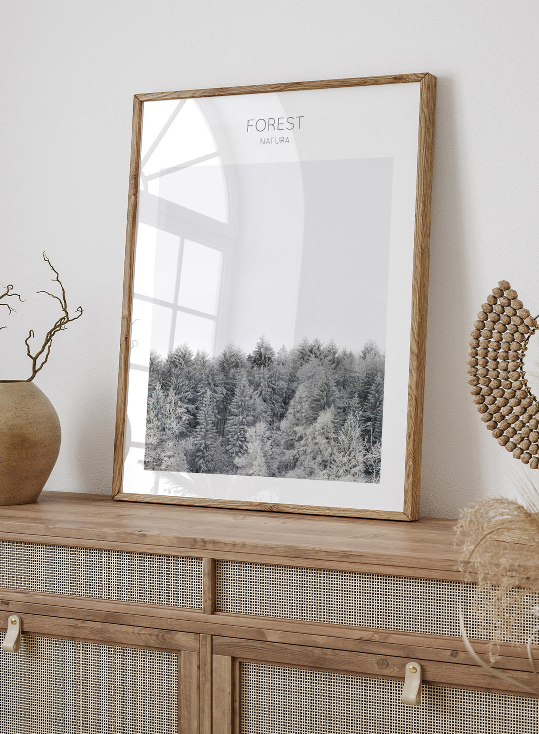 Black and white forest landscape with 'FOREST' and 'Natura' text at the top. Frosted Tranquility by The MIUUS Studio is a black and white forest photography art print and wall poster featuring snowy trees, minimalist composition, and modern neutral design.